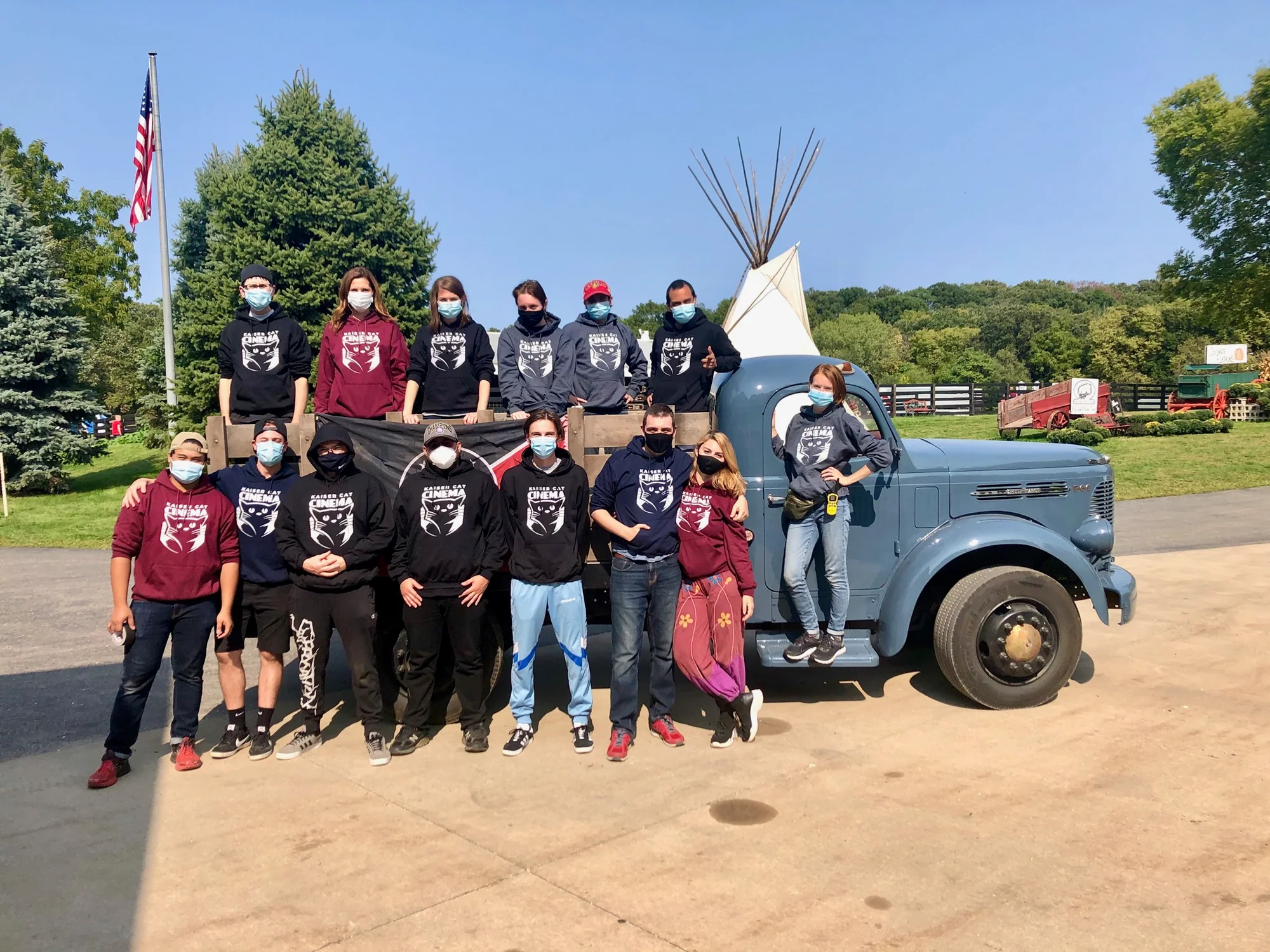 American Kingdoms example: The Kaiser Cat Collective team gathered in front of a vintage truck